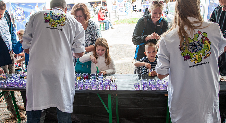 Kids at a booth playing with slime 